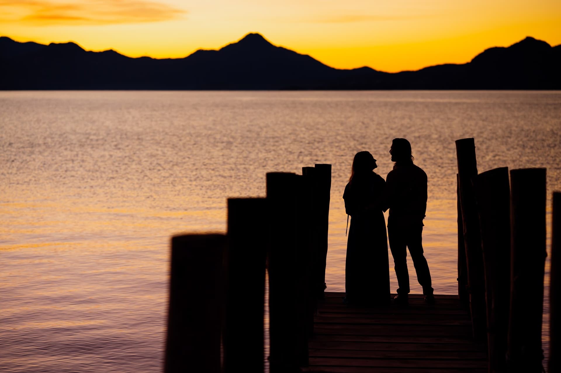 Silhouette of a couple at sunset on Lake Atitlán, Guatemala