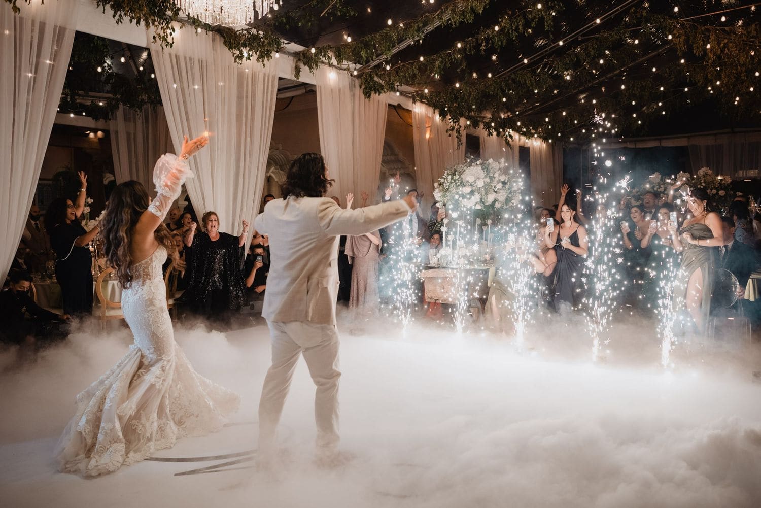 Couple dances surrounded by cold-fountain sparklers and cheering guests at the Hotel Pensativo reception in Antigua Guatemala.