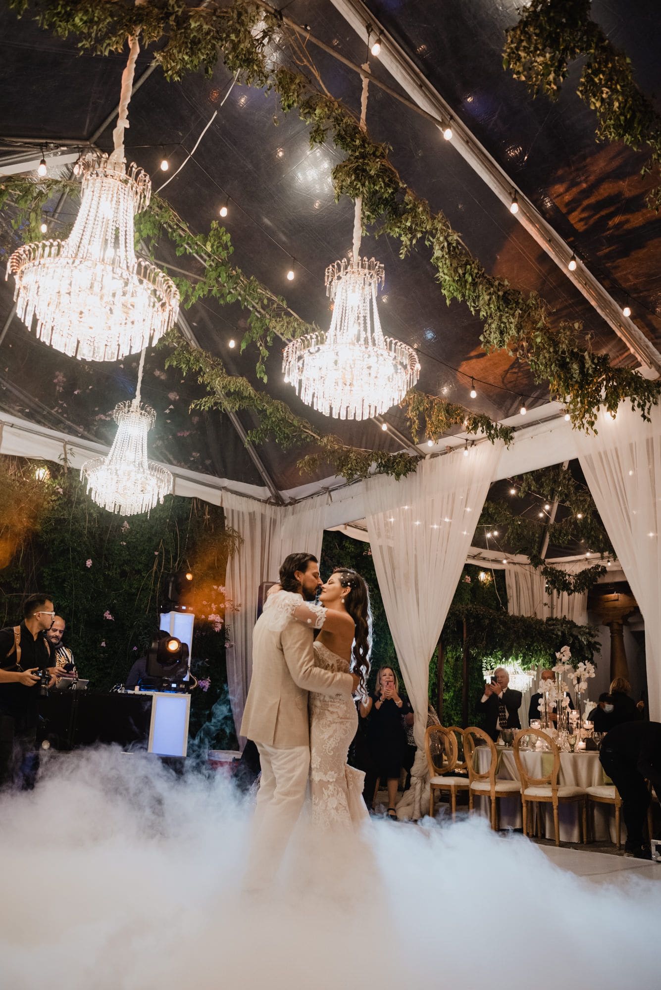 First dance under crystal chandeliers and hanging greenery on a fog-covered dance floor at Hotel Pensativo, Antigua Guatemala.