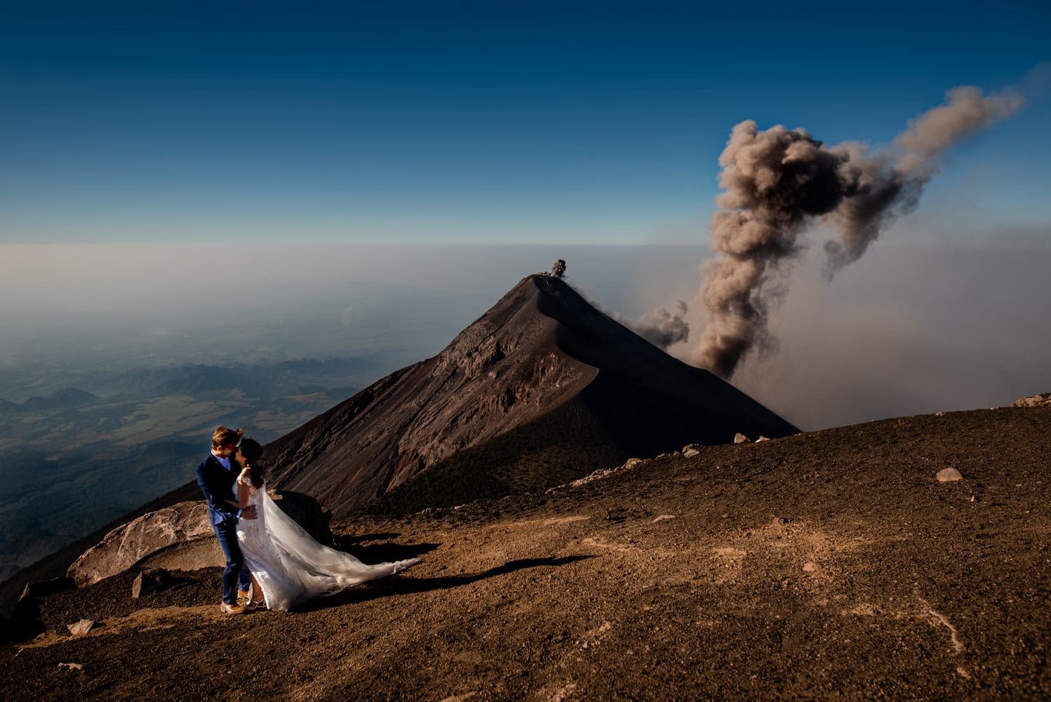Couple posing on a rocky slope