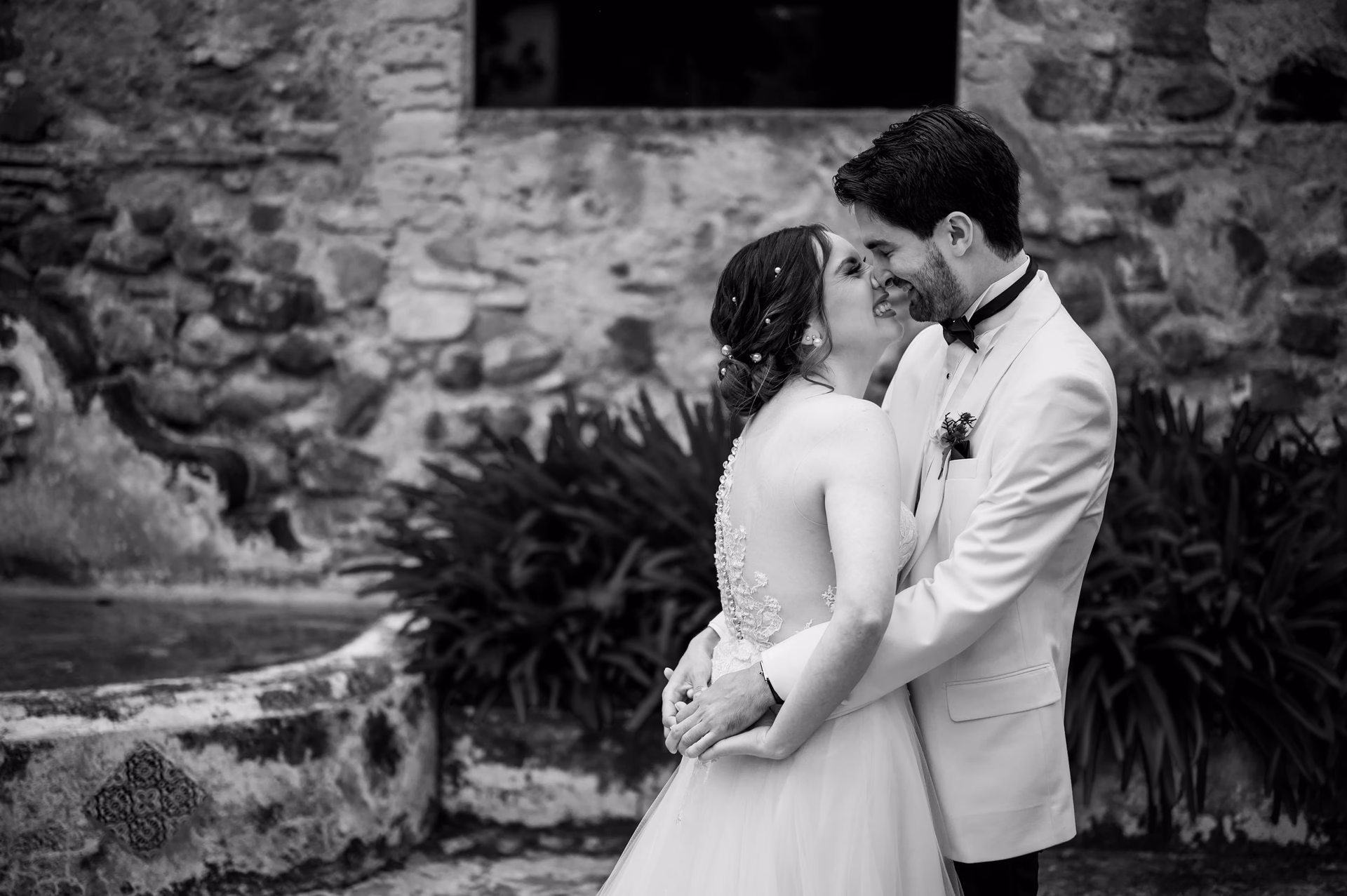 Newlywed couple sharing an intimate black-and-white moment