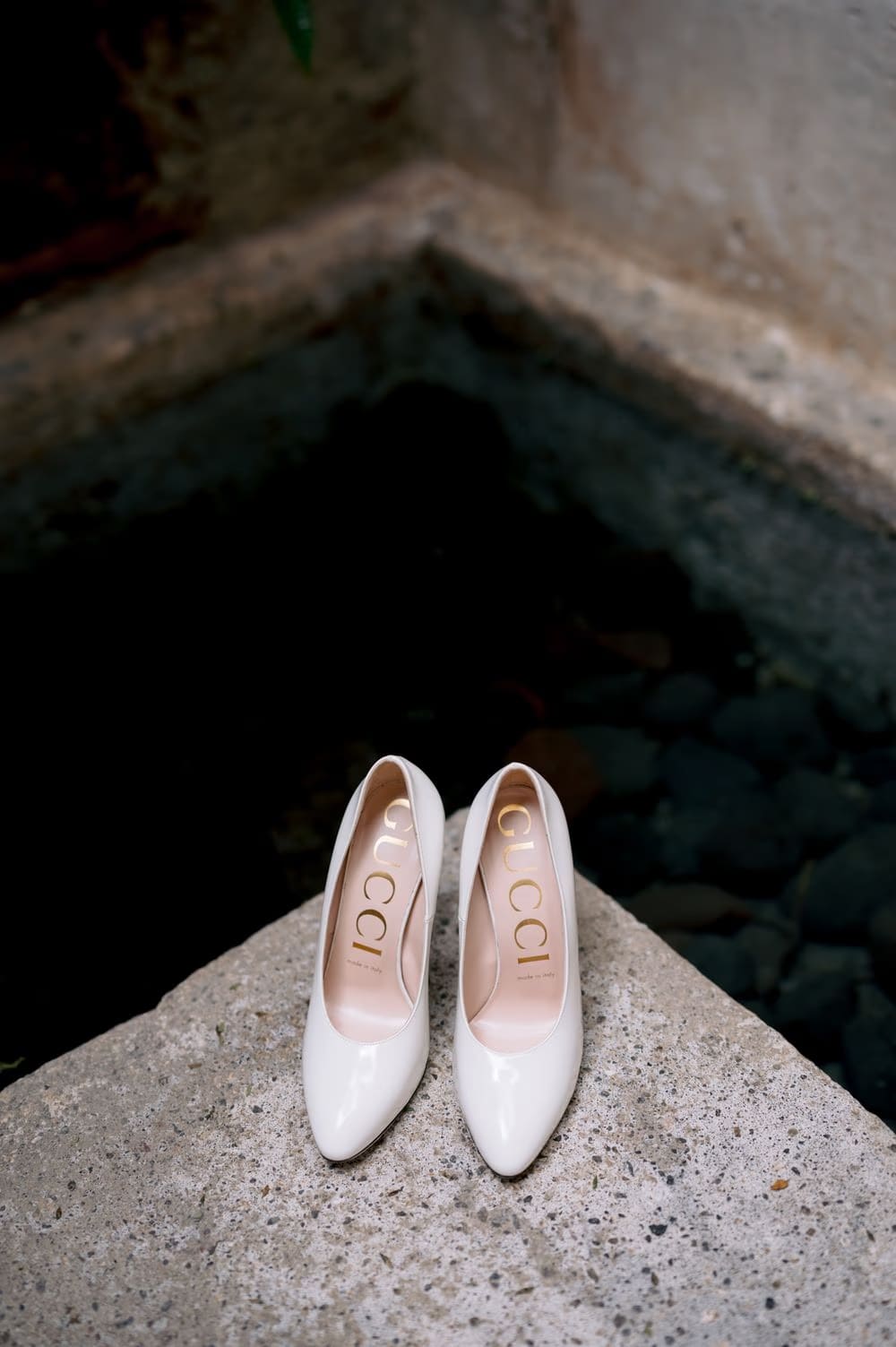 Bridal Gucci pumps resting on a stone ledge — getting-ready detail at El Convento Boutique Hotel.