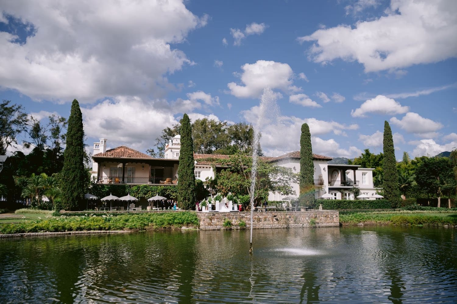 Villa Bokeh main house reflected in the lagoon under blue sky in Antigua Guatemala.