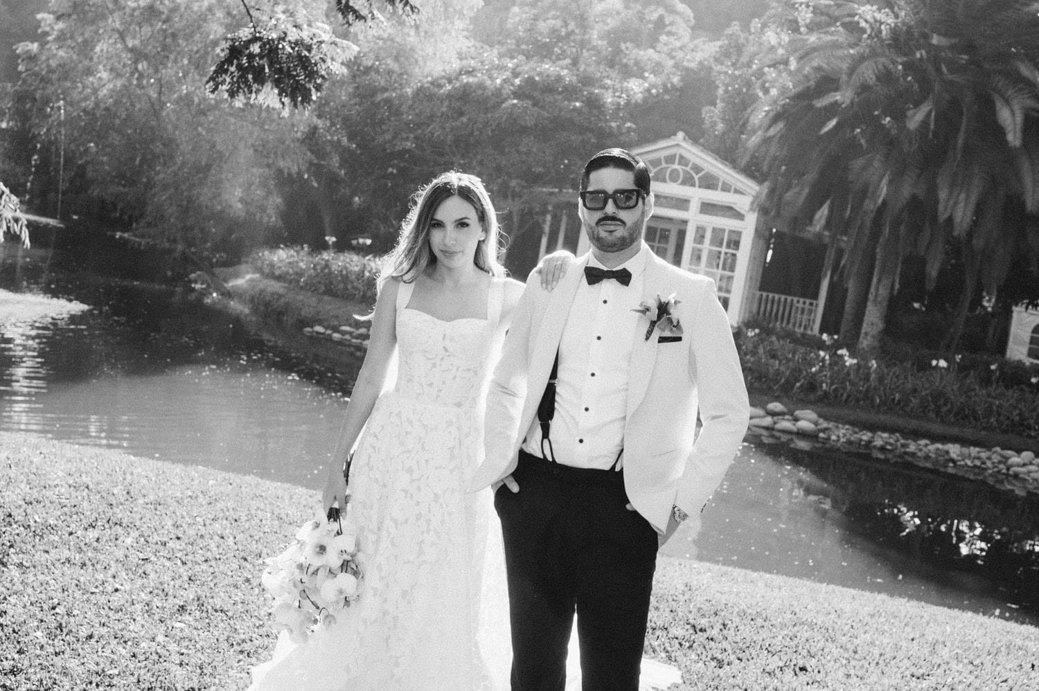 Couple portrait by the lagoon in soft black and white — destination wedding in Antigua Guatemala.