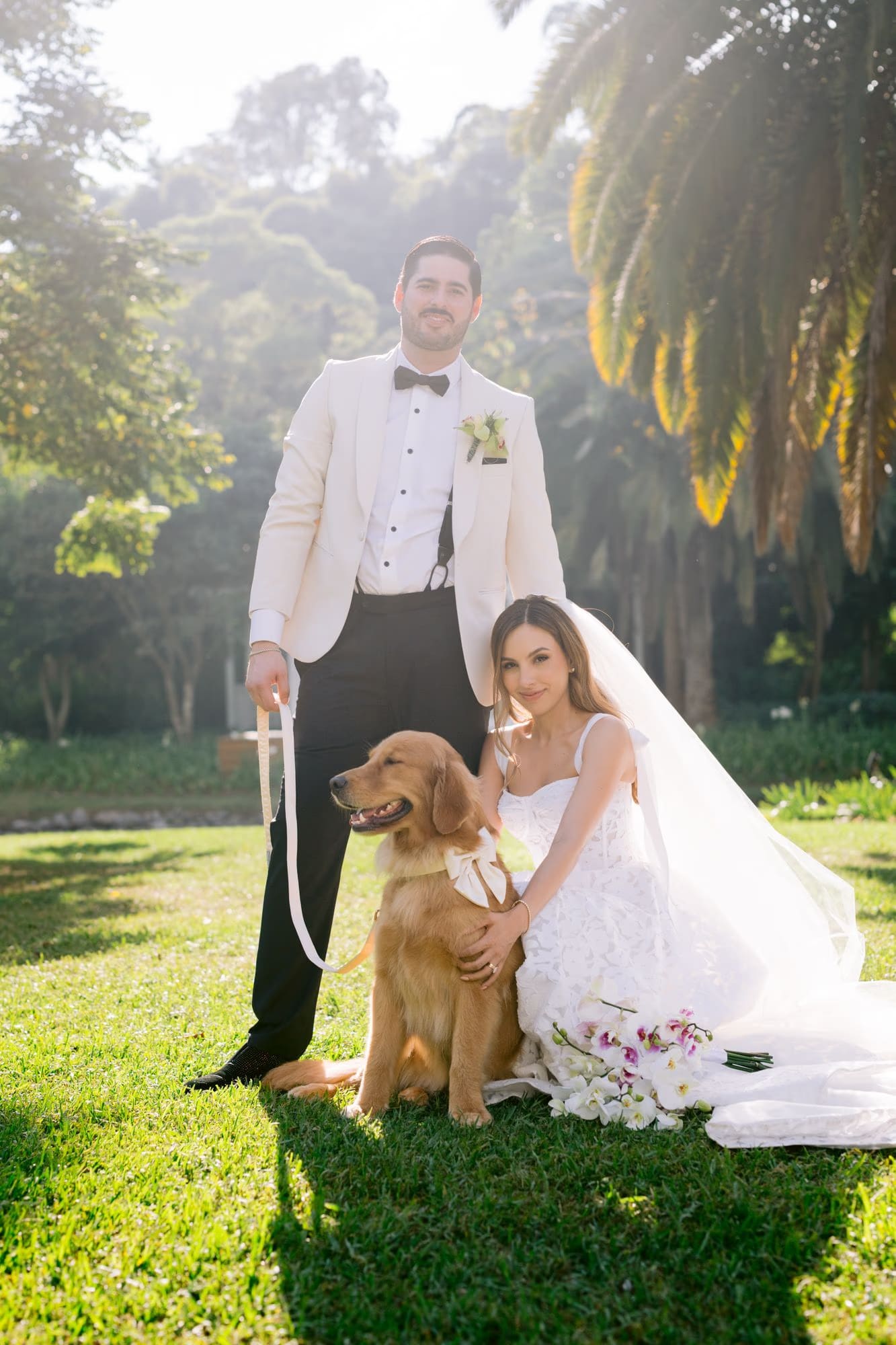 Formal portrait of bride, groom and Nala the golden retriever on the lawn at Villa Bokeh, Antigua Guatemala.