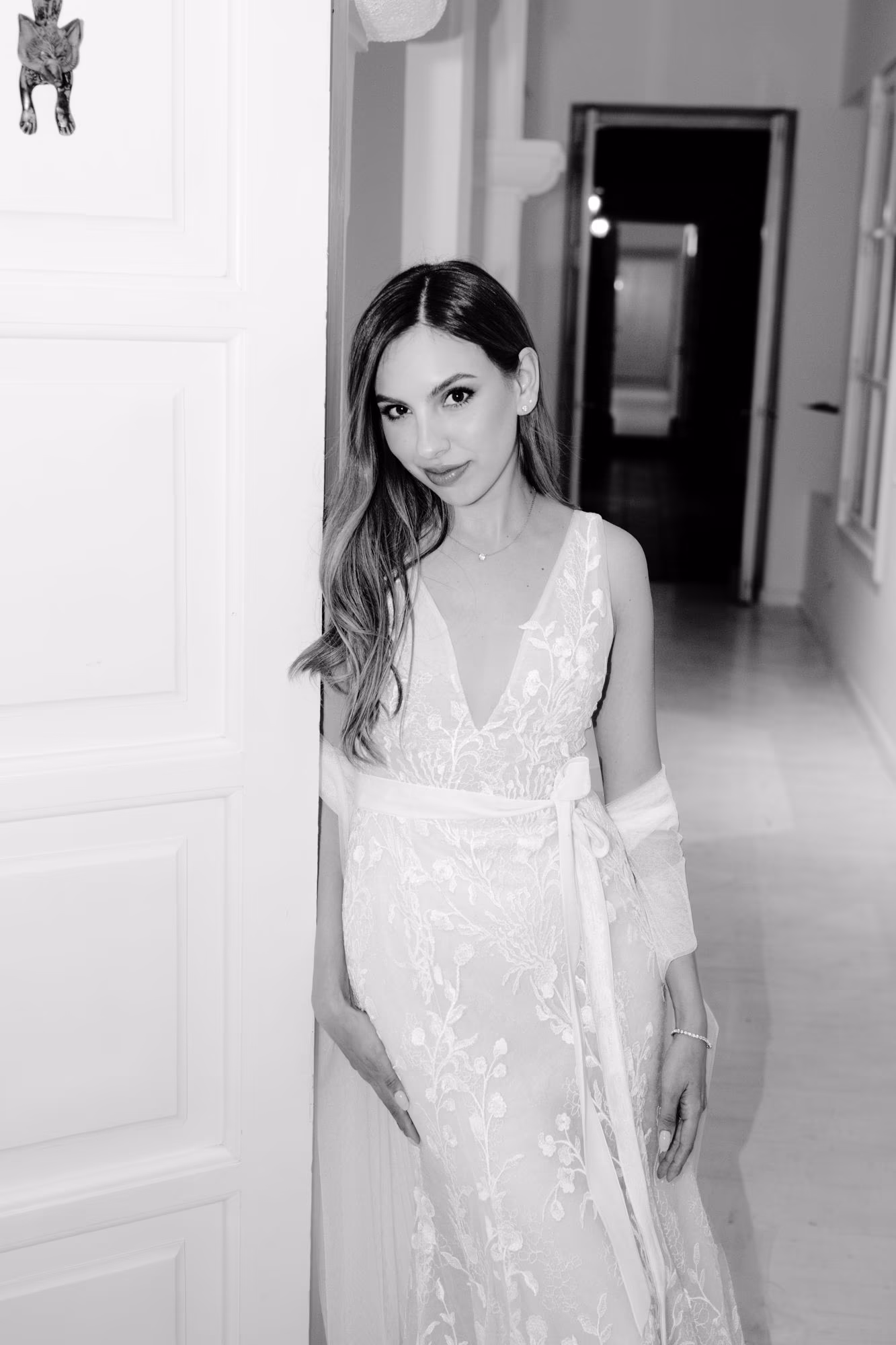 Close bridal portrait of Caro in a colonial doorway, embroidered dress and soft smile — Antigua Guatemala.