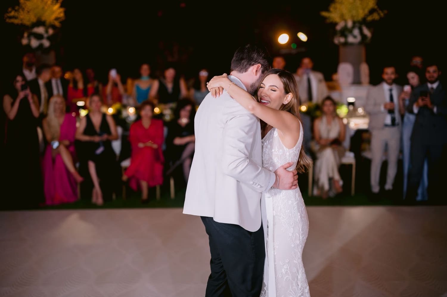 Bride and groom share their first dance surrounded by cheering guests at the reception in Antigua Guatemala.