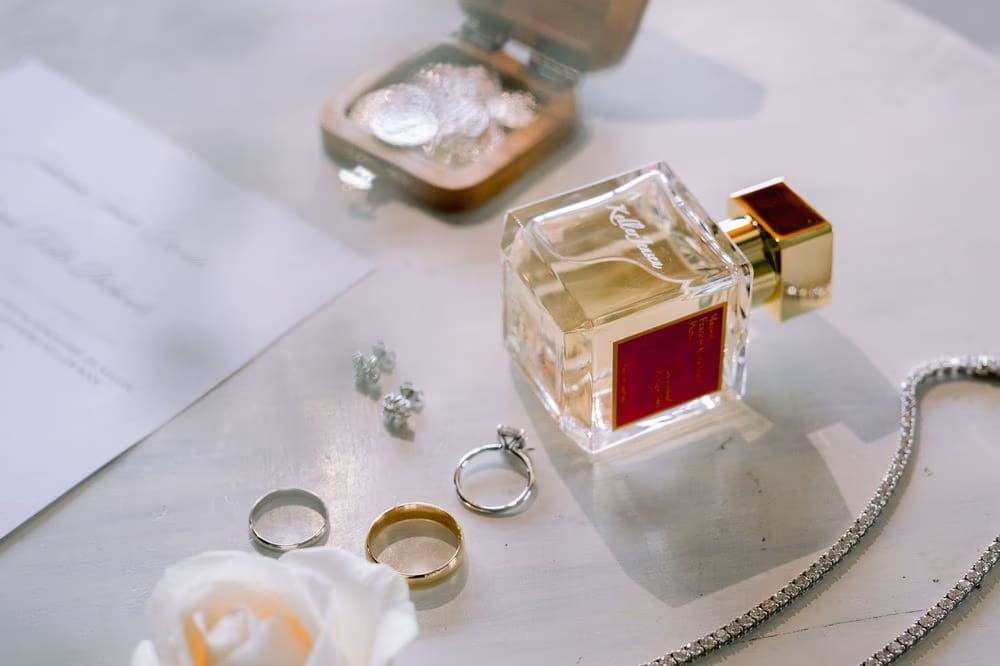 Bridal perfume, engagement ring and wedding bands styled with the invitation suite before the ceremony — destination wedding details in Antigua Guatemala.