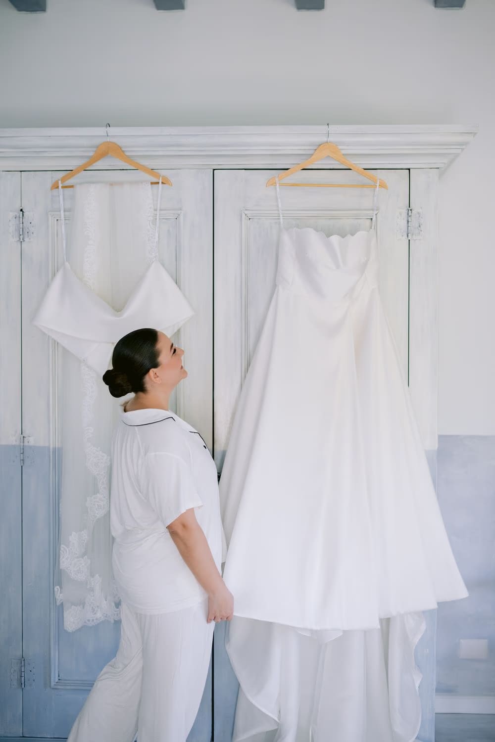 Johanna looks at her wedding gown the morning of the ceremony — getting-ready moment at Villa Bokeh.