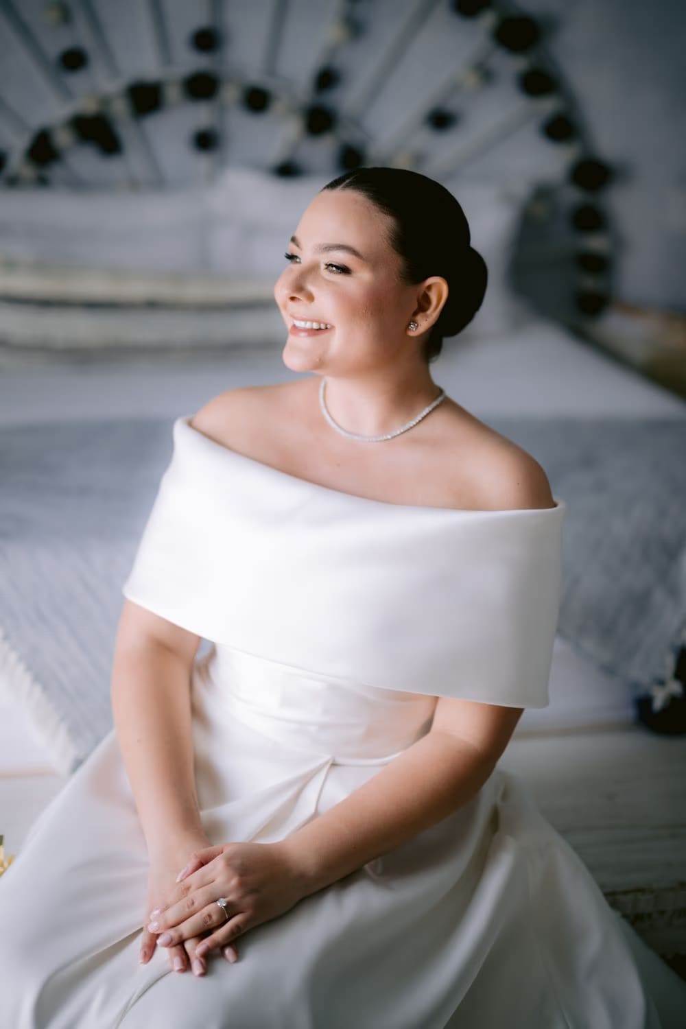 Bride Johanna laughs in her ivory off-shoulder gown — editorial bridal portrait.