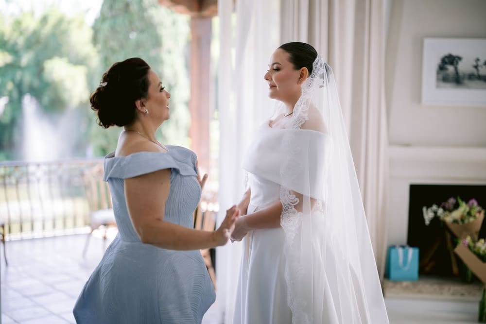 Mother of the bride helps Johanna adjust her veil moments before leaving for the church.