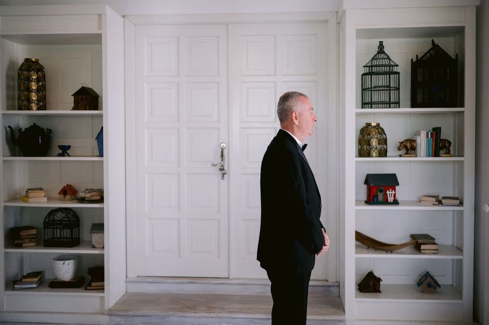 Father of the bride stands ready in the library before the first look in Antigua Guatemala.