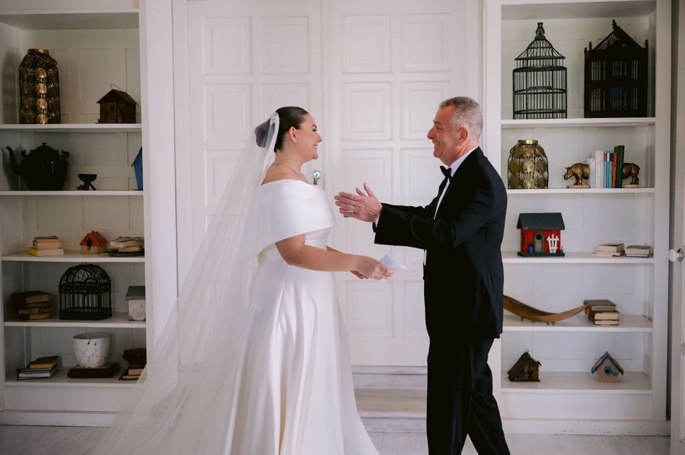 Father and bride share words and an applause moment during their first look in Antigua Guatemala.