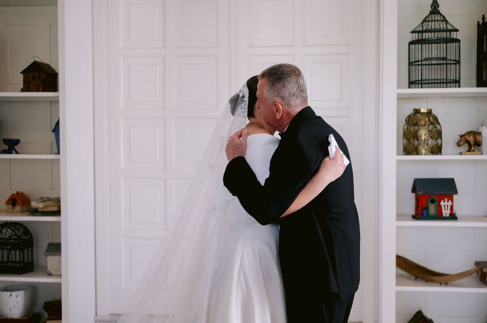 Bride and father embrace tightly during their first look — destination wedding in Antigua Guatemala.