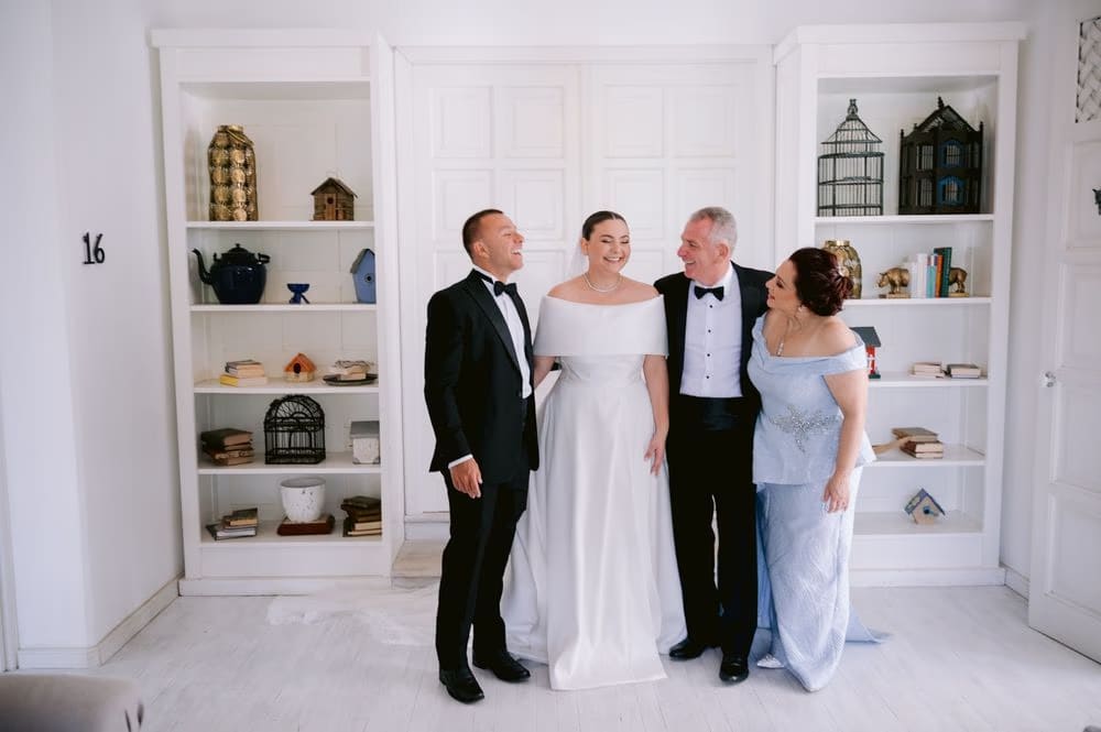 Johanna poses with her parents and brother in their formalwear before leaving for the ceremony.