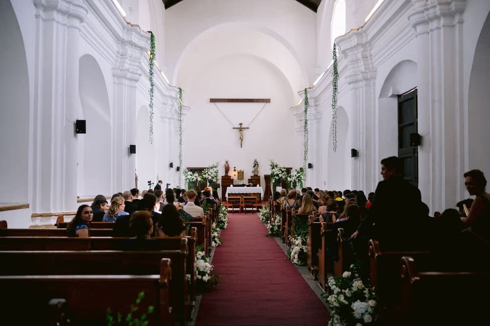 Guests fill the colonial church awaiting the bride's entrance — destination wedding in Antigua Guatemala.