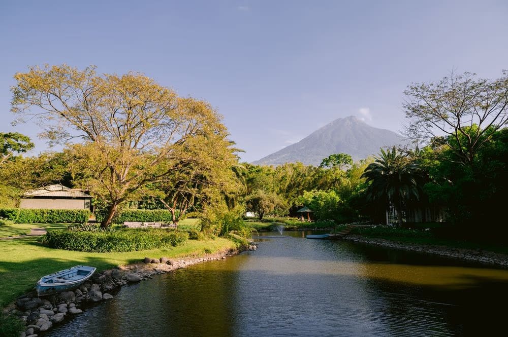 Fountain and volcano landscape framed by jacarandas at the venue in Antigua Guatemala.