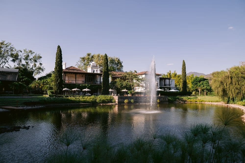Hacienda-style facade with a tall fountain at the venue grounds — wedding day at Villa Bokeh.