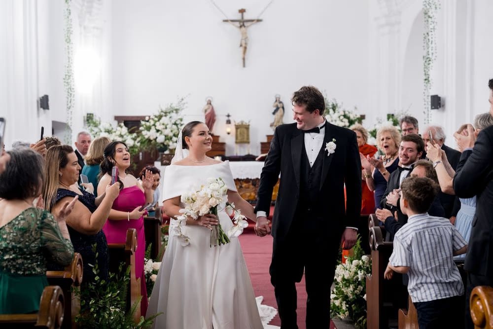 Johanna and Thomas walk back down the aisle to cheers and applause after the ceremony.