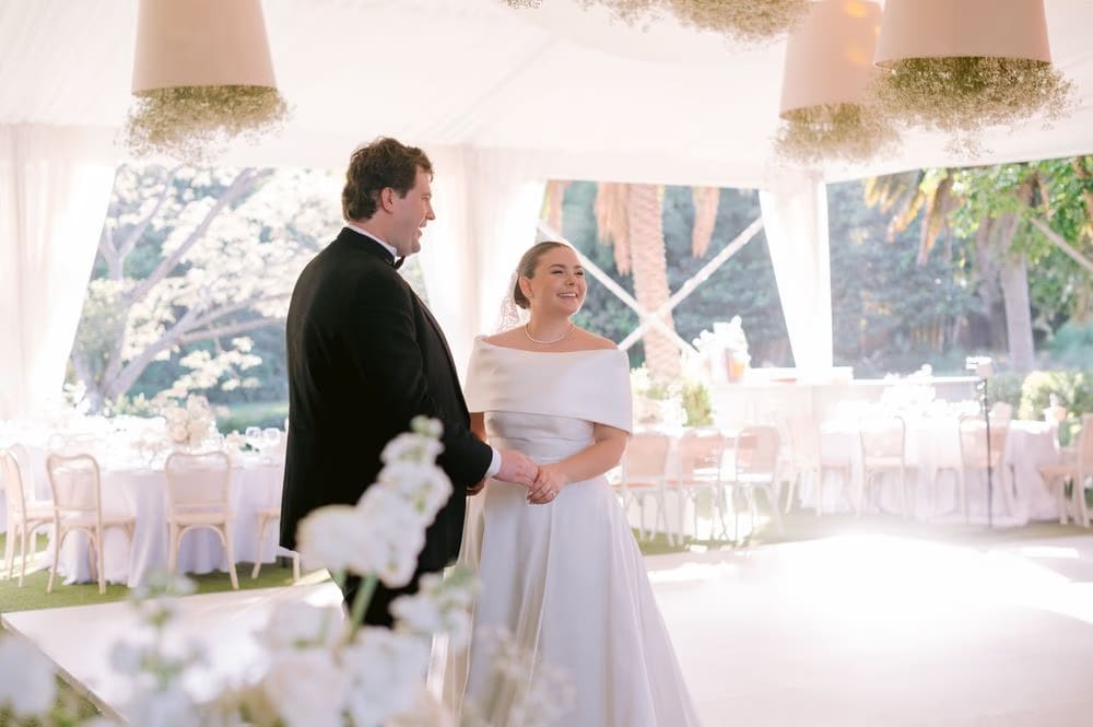 Bride and groom step onto the dance floor under the canopy as the reception begins at Villa Bokeh.