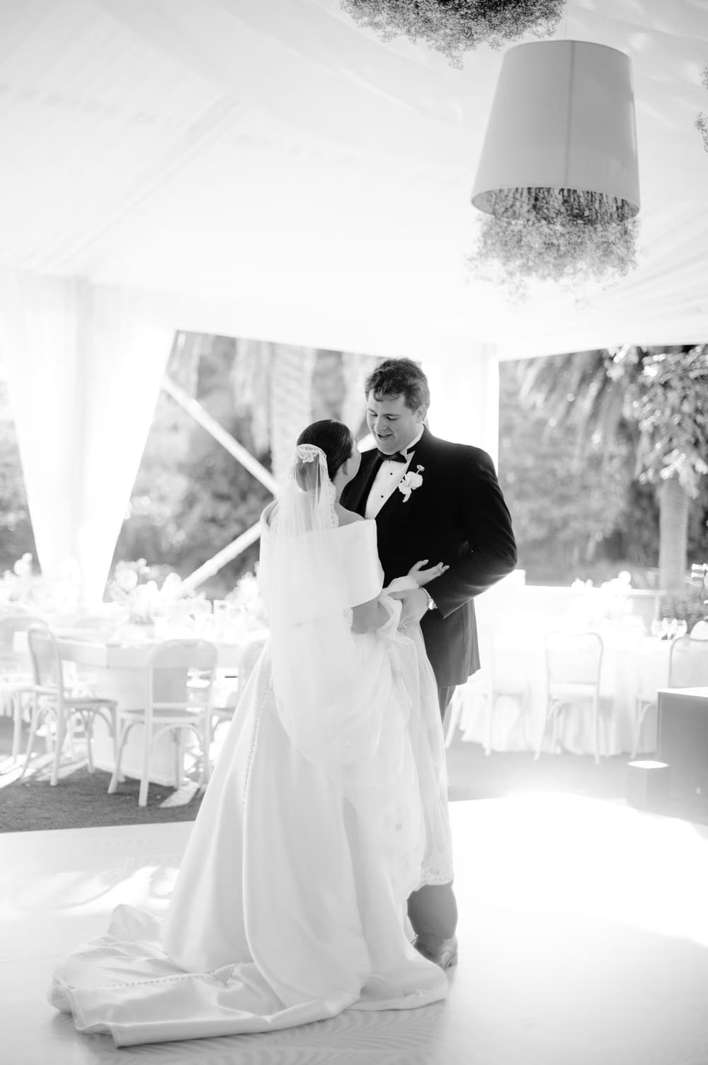 Black-and-white first dance under the tented canopy — open-air wedding at Villa Bokeh.
