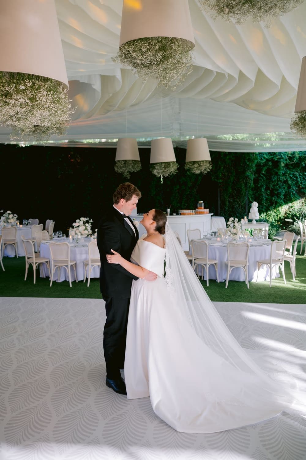 Couple's first dance beneath chandeliers wrapped in baby's breath at Villa Bokeh, Antigua Guatemala.