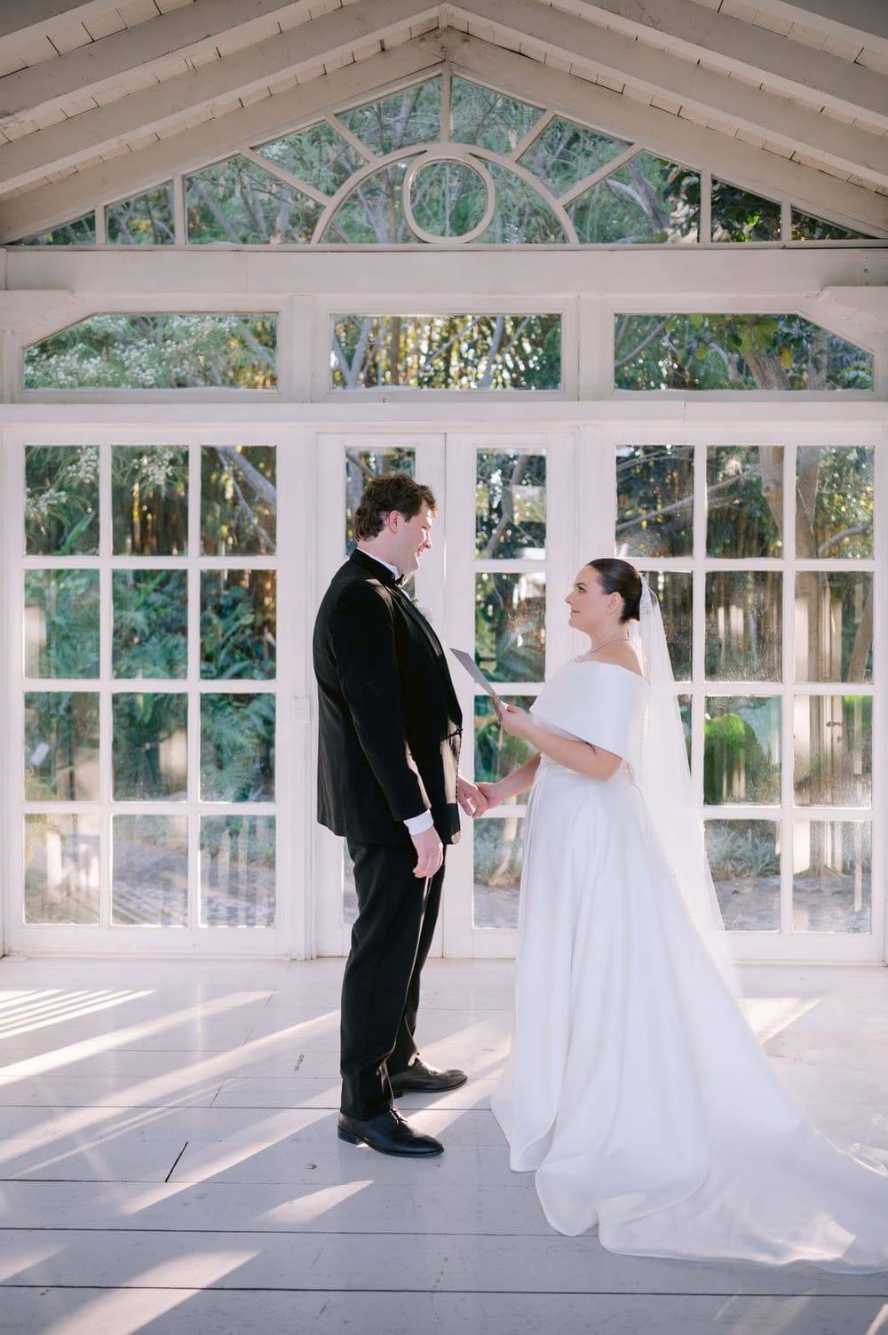 Bride and groom share private vows inside the glass garden gazebo at Villa Bokeh, Antigua Guatemala.
