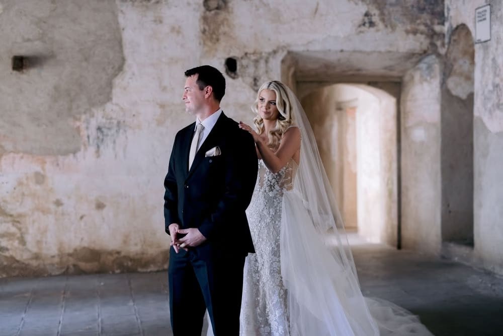 Bride taps her groom's shoulder for their first look at Santa Clara Ruins, Antigua Guatemala.