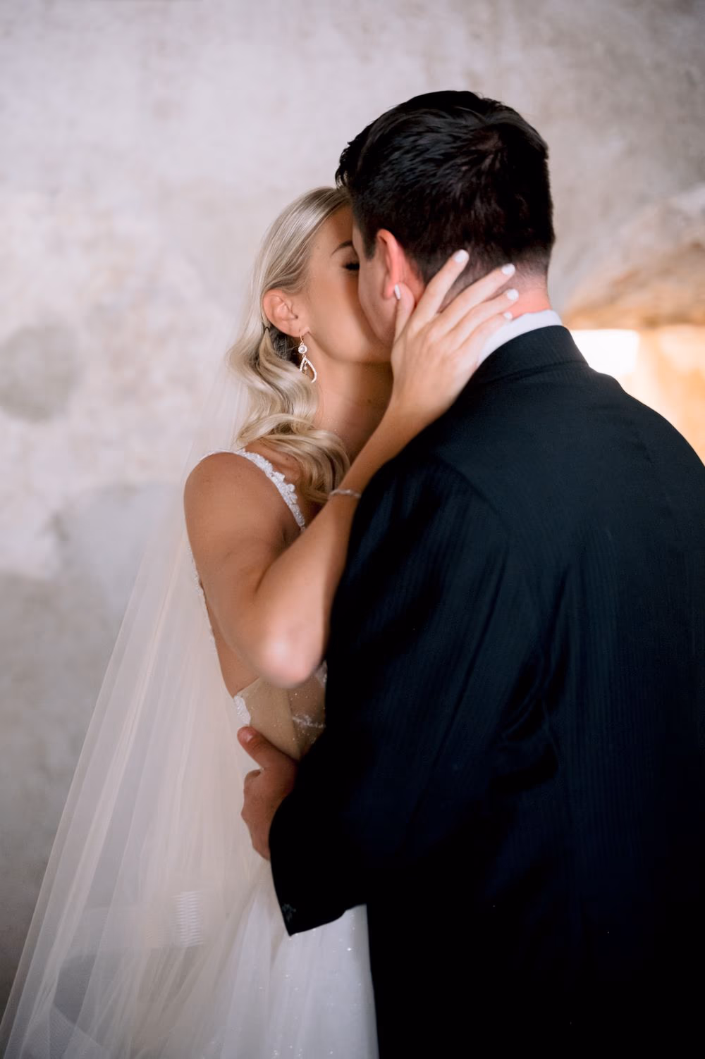 Bride pulls her groom into a tender kiss after seeing him for the first time at Santa Clara, Antigua Guatemala.