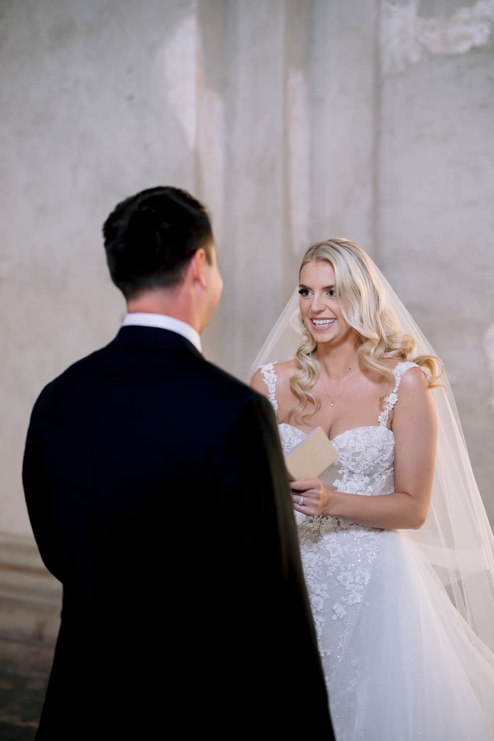 Bride smiles widely as she shares her vows with her groom during a private vow exchange at Santa Clara.