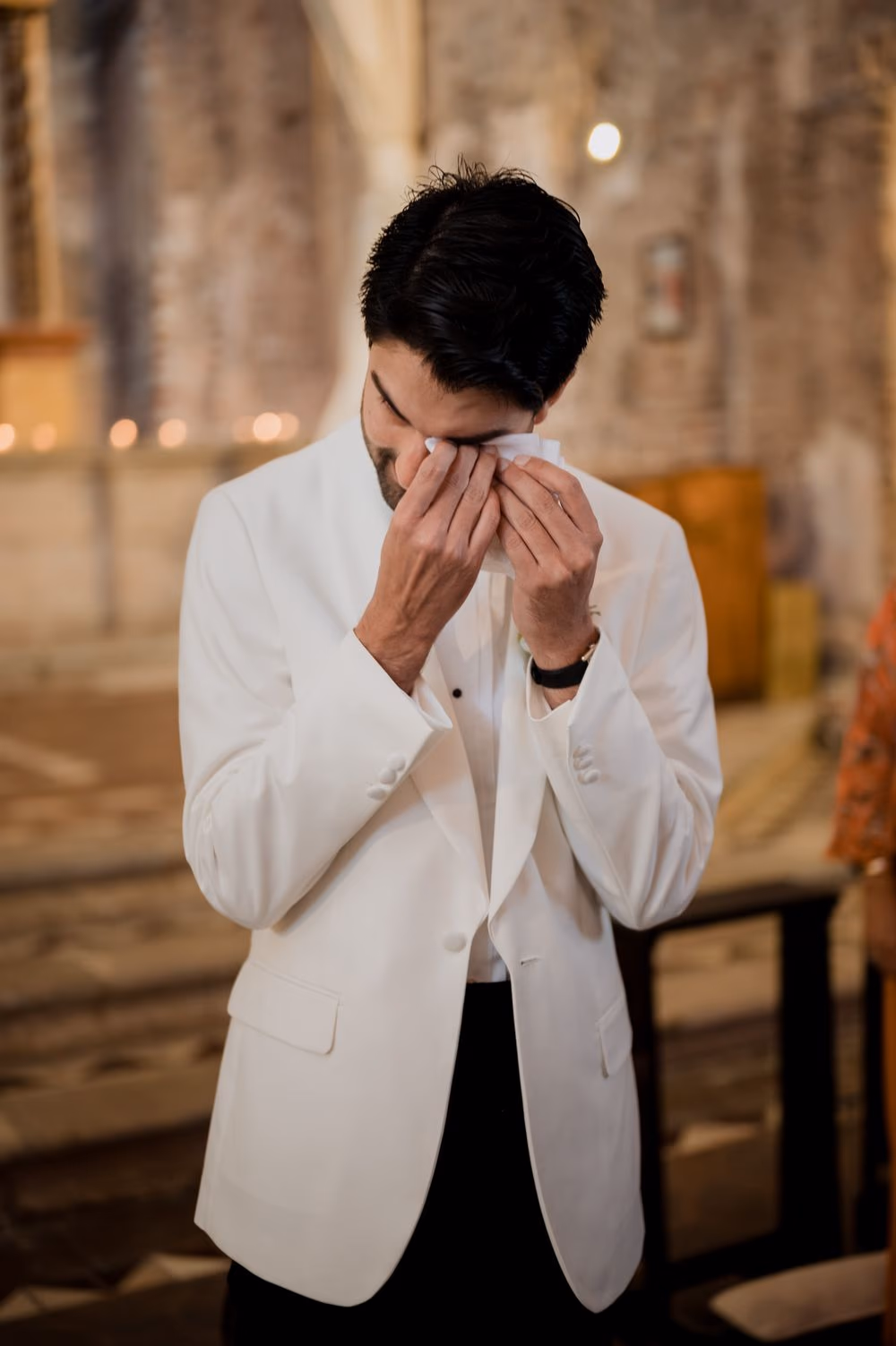Groom wipes away tears at the altar as he watches the bride walk down the aisle at Casa Santo Domingo.
