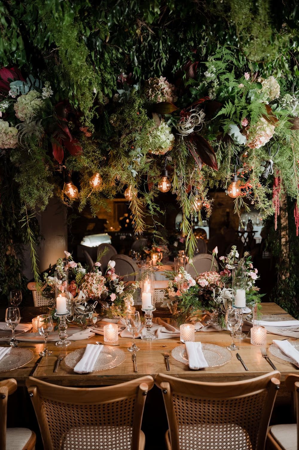 Reception tablescape with hanging garden of greenery, candles and blush florals by Addy Florales at the colonial monastery.